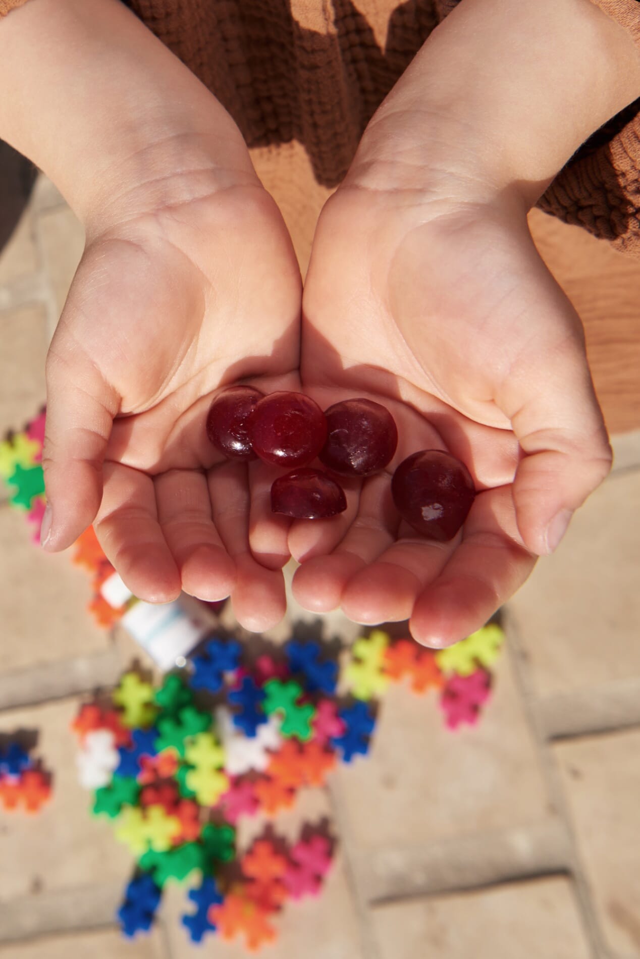 Un enfant tient ses gummies Mon Petit Valebio au creux des mains
